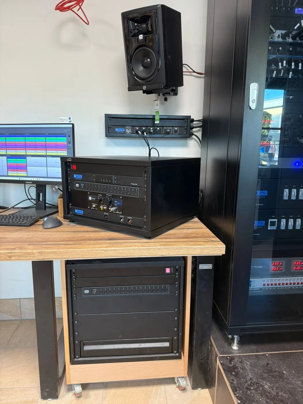 Technical room with amplifier rack and control screens